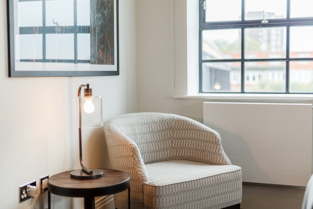 Chair and table lamp in Palace Wharf flat.